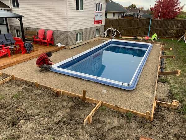 A square fiberglass pool installation in progress