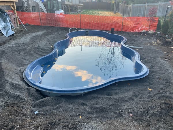 A backyard pool installation in progress