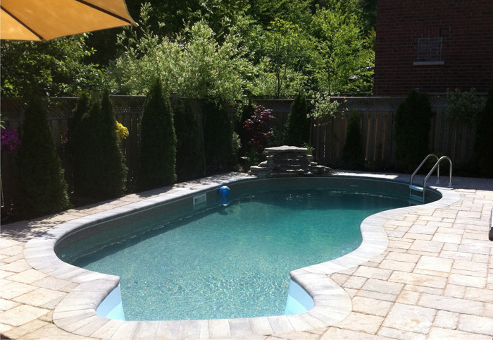 Fiberglass pool in a backyard