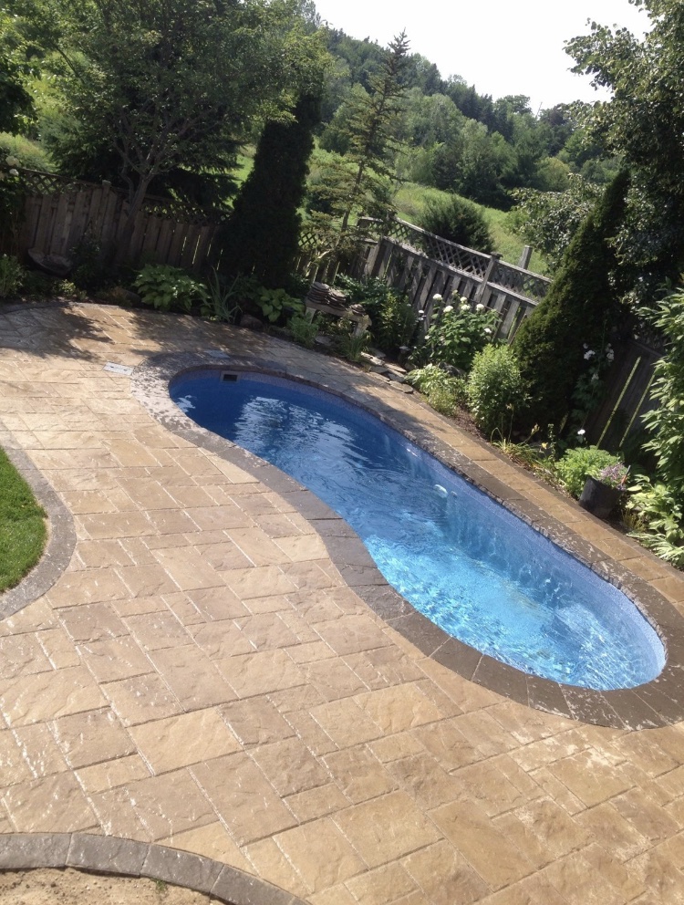 Fiberglass pool in a backyard